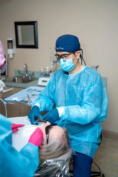 Dr. Kang performing a restorative dentistry procedure on a patient in Everett, WA