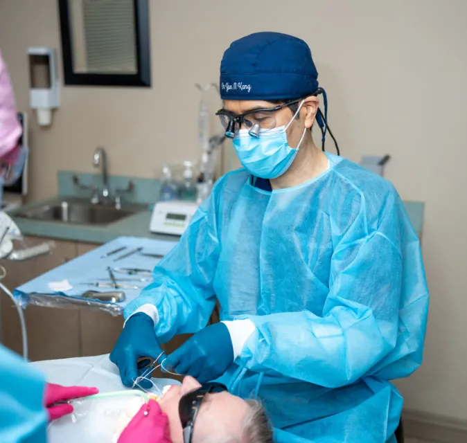 Everett, WA dentist Dr. Yun Kang performing dental work on a patient